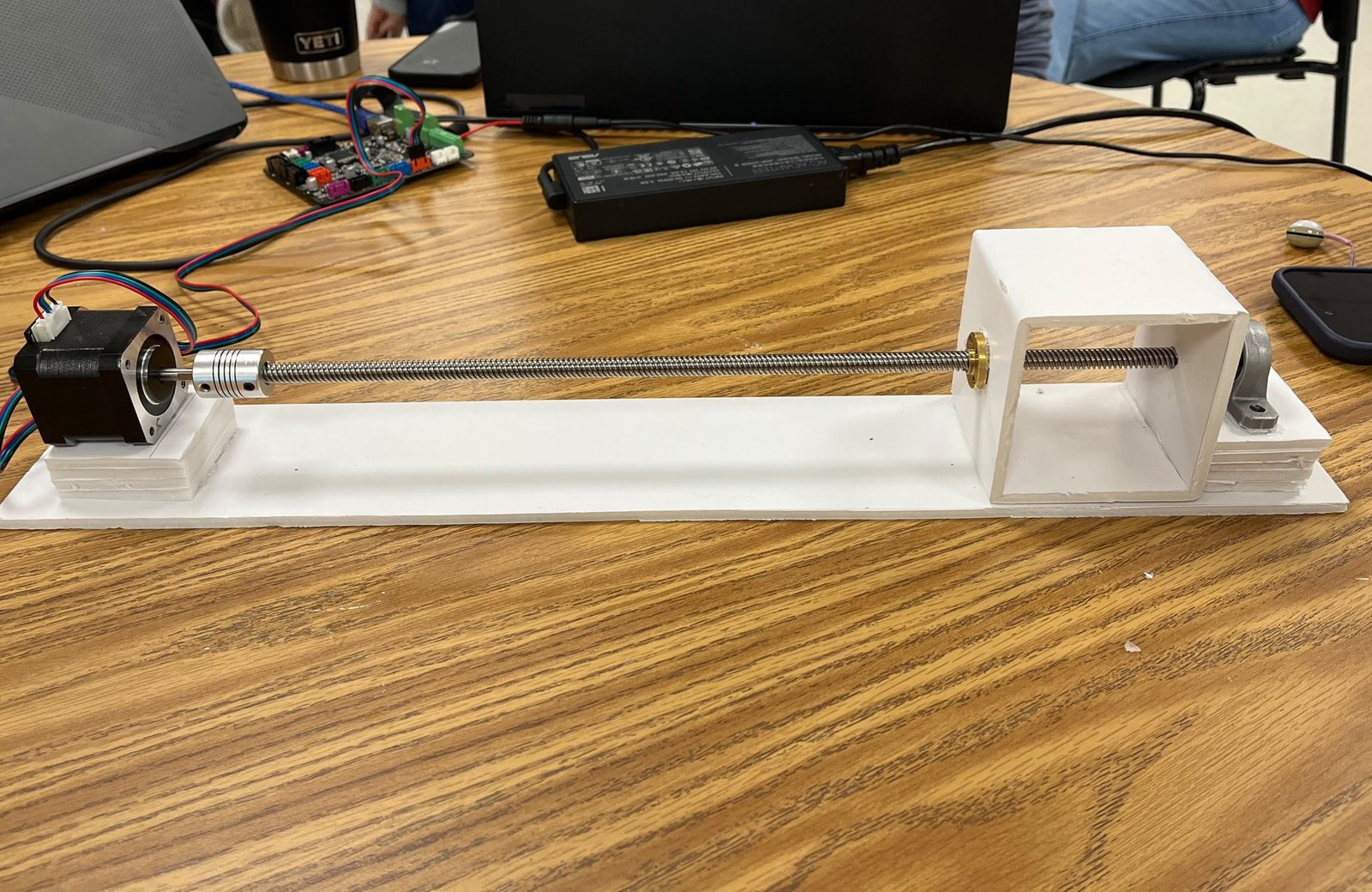 Single-axis plotter prototype with a stepper motor, lead screw, carriage, and controller